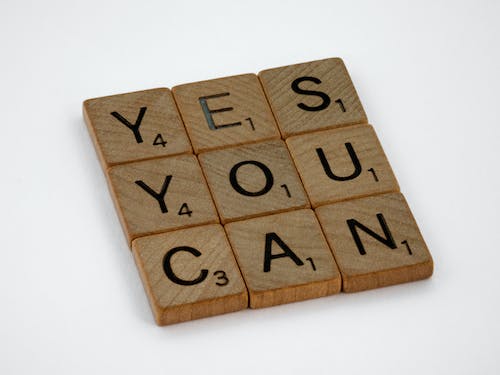 Free Close-Up Photo of Yes You Can Text on White Surface Stock Photo